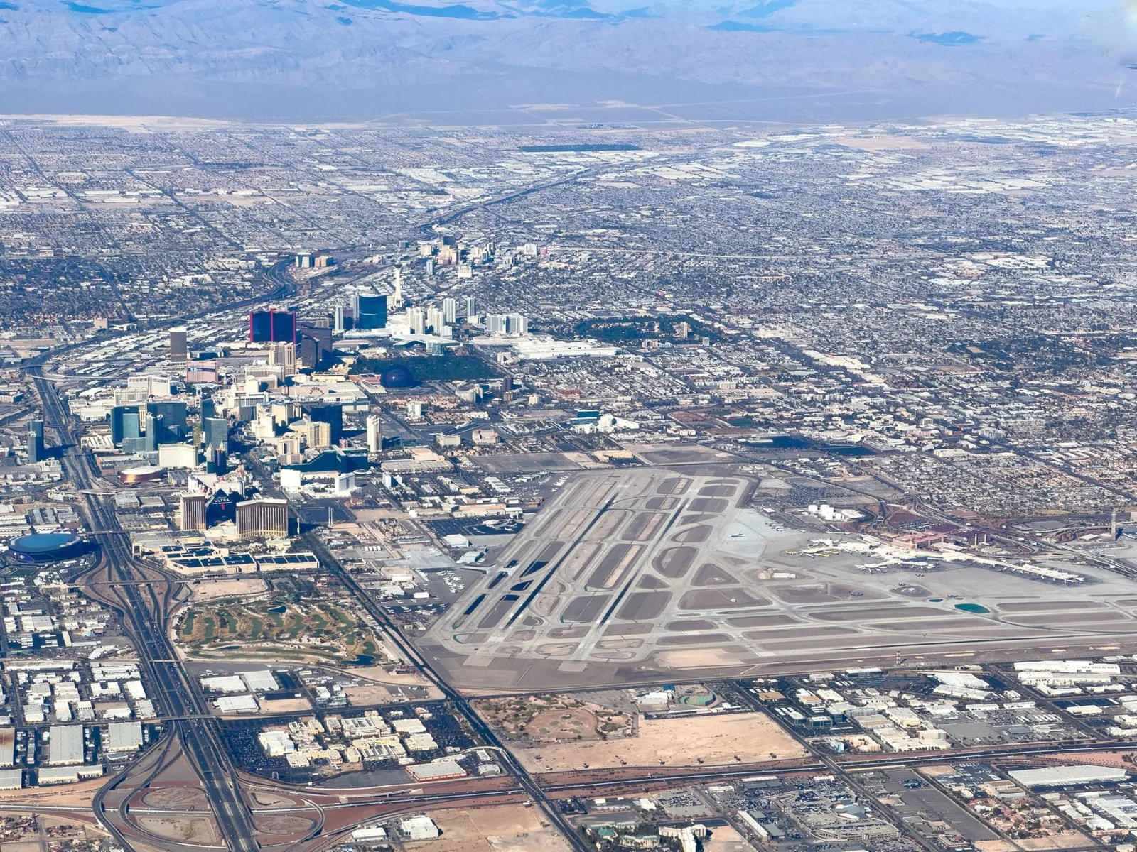 airplane window view approaching Las Vegas at dusk